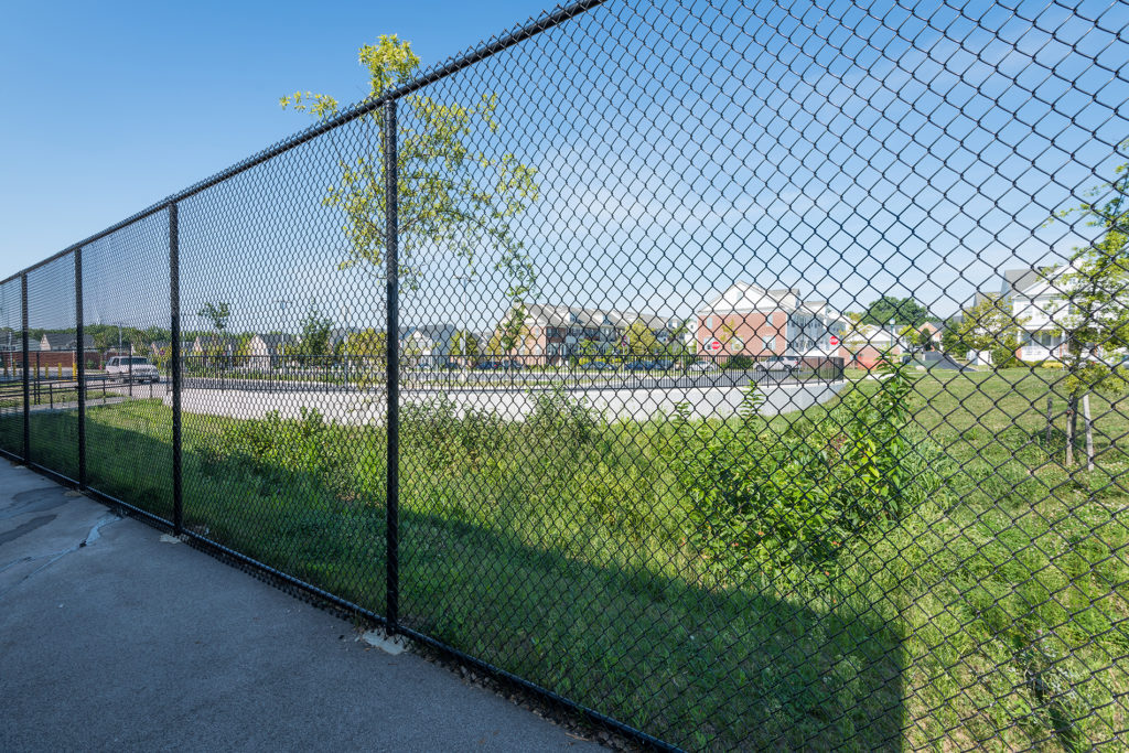 Tall black chain link, commercial perimeter, style we install